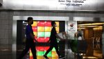 Dua orang pekerja melintas di dekat layar pergerakan Indeks Harga Saham Gabungan (IHSG) di Gedung Bursa Efek Indonesia (BEI), Jakarta, beberapa waktu lalu. (Foto: Erman Subekti)