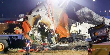 Petugas pemadam kebakaran dan petugas penyelamat bekerja di dekat lokasi jatuhnya pesawat Jeju Air. (foto: isitmewa)